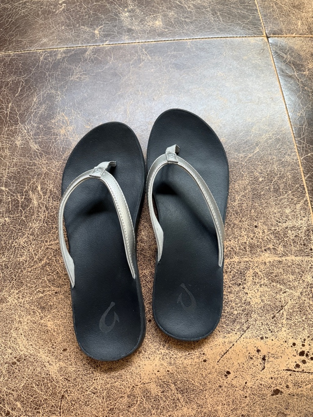 OluKai Black Footbed Flip-Flops with Silver Straps